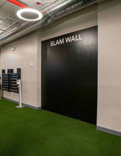A gym with two punching bags and a door.